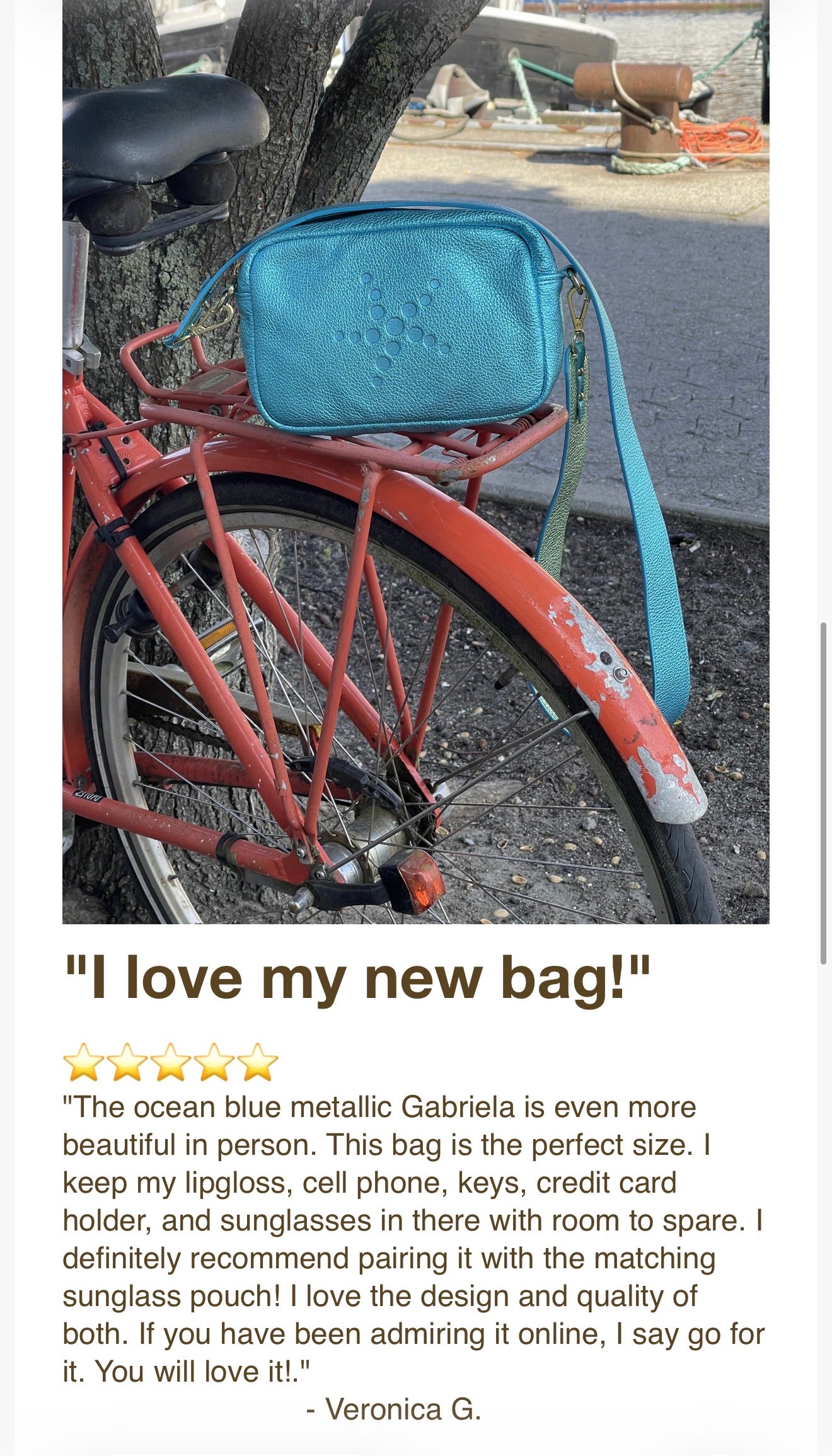 Red bicycle with a blue metallic Gabriela bag attached, featuring a customer review.