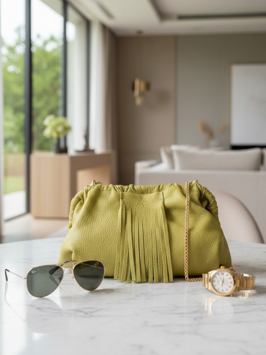 Natalia - Full Grain Leather Clutch Bag - Vinaigrette with sunglasses and watch on a marble surface in a modern room.